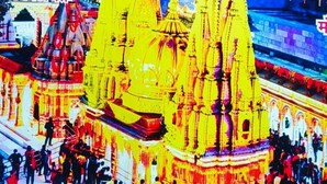 A digital display of a temple with a crowd, and a sign indicating check-in and check-out times. - Shivashram Guest House (Varanasi)