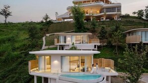 A modern, multi-level residential building with a pool area, surrounded by greenery. - Kiri Rhom Khao Kho (Khao Kho)