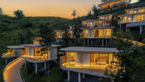A modern hillside property with multiple connected buildings, featuring large glass windows and outdoor seating areas. - Kiri Rhom Khao Kho (Khao Kho)