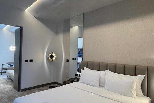 Deluxe Suite, Balcony, City View | Minibar, in-room safe, desk, laptop workspace