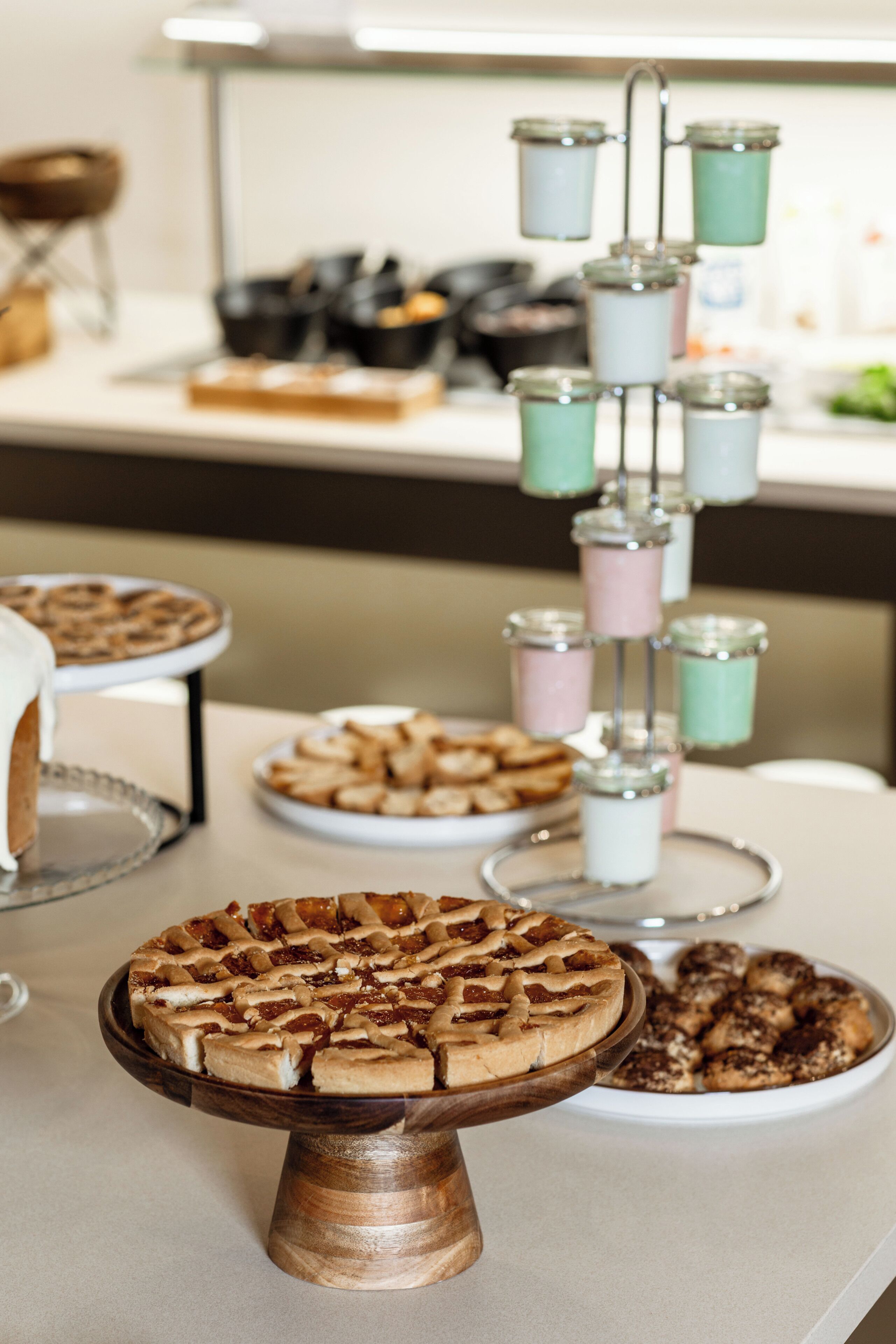 A buffet table with various food items and a tiered drink dispenser.