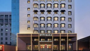 A modern hotel building with multiple floors and a prominent entrance.