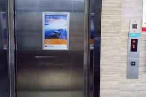 An elevator with a digital display and a poster on the door. - Yeste Hotel (Yulin Culture Square) (Yulin)