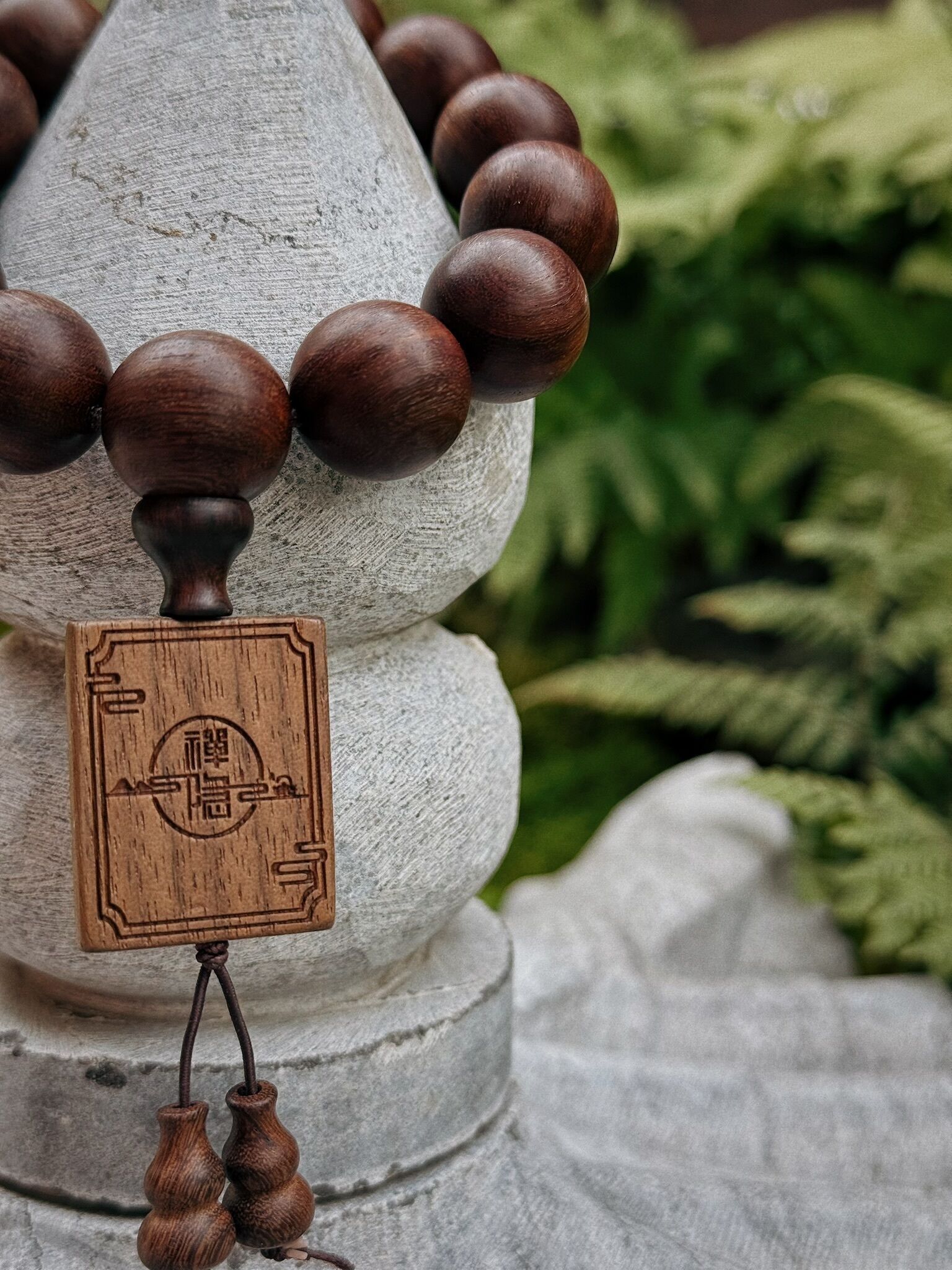 A decorative wooden structure with spherical elements and a carved wooden plaque.