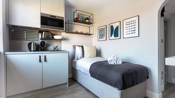 1 bedroom, desk, iron/ironing board, travel crib