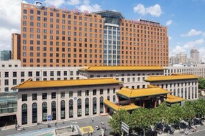 A large hotel building with a prominent entrance and a modern glass structure. - Ji Hotel (Shanghai Xietu Road) (Shanghai)