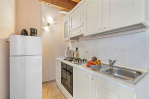 Family Apartment, 2 Bedrooms (Two Bedroom Apartment Cascina) | Private kitchen | Fridge, oven, stovetop, coffee/tea maker
