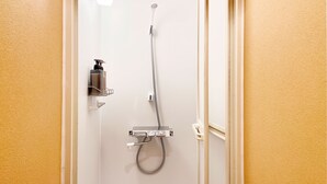 A bathroom with a shower, a soap dispenser, and a towel rack. - Backpackers Jinya (Takayama)