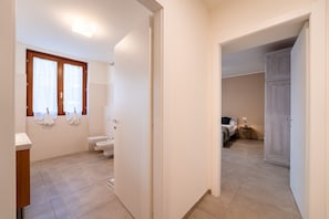 A modern bathroom with a toilet, bidet, and sink. - Lighthful Apartment in Valbrona by Wonderful Italy (Valbrona)