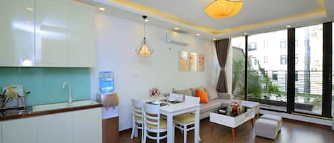 Luxury Apartment, Garden View | Living area | 50-inch TV with cable channels