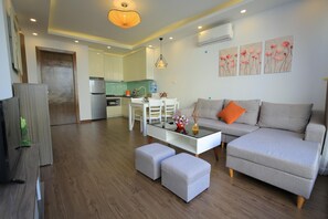 Luxury Apartment, Garden View | Living area | 50-inch TV with cable channels, fireplace