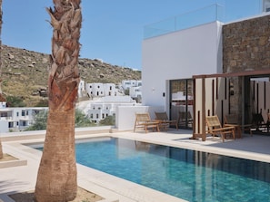 Seasonal outdoor pool, open 11:00 AM to 9:00 PM, pool umbrellas