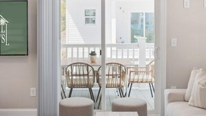 A modern living room with a sliding glass door leading to an outdoor patio. - Capers Blade-Across Beach-Garage (Myrtle Beach)