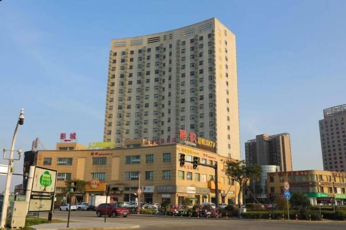 A multi-story building with commercial establishments on the ground floor, including a KTV.