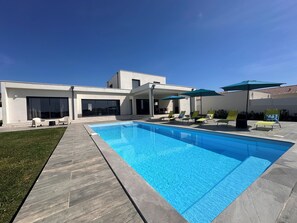 A modern house with a swimming pool, outdoor seating, and a covered patio area. - SPACIOUS VILLA 220M2 FULLY AIR-CONDITIONED PRIVATE POOL / FENCED GARDEN (ALERIA)