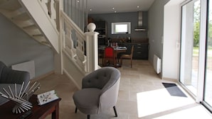A modern interior with a staircase, a dining area, and a kitchen. - Charming cottage in the heart of the Vosges (Removille)
