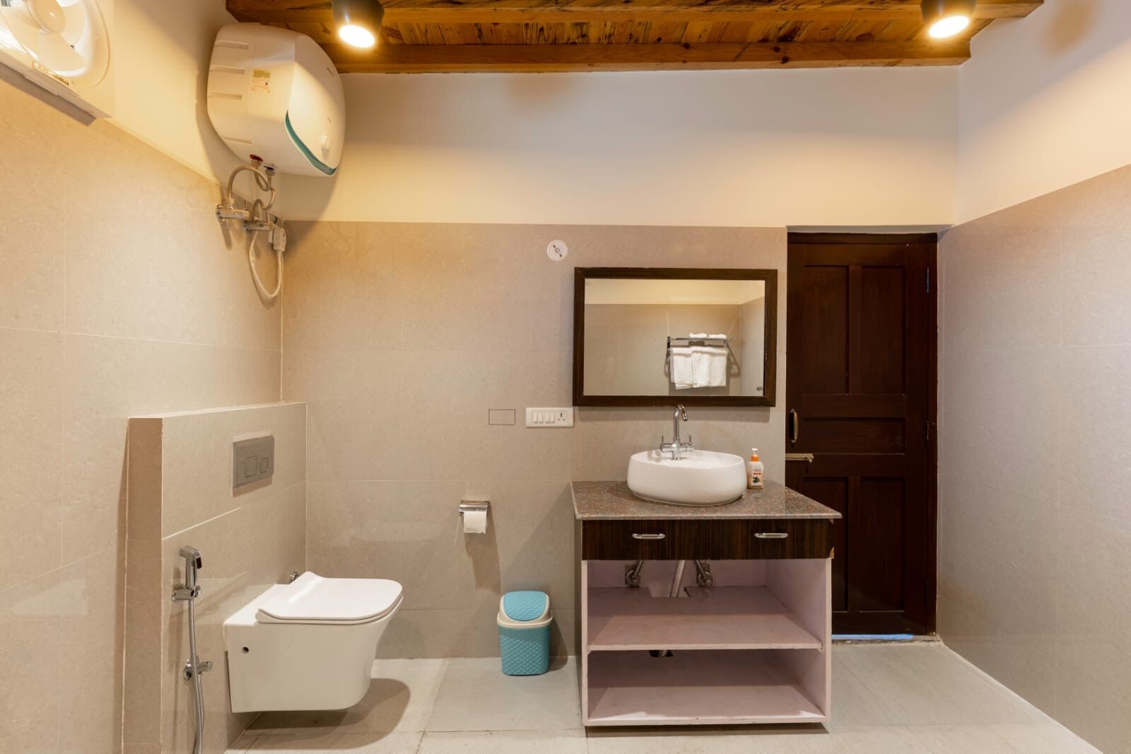 A bathroom with a toilet, sink, and shower.