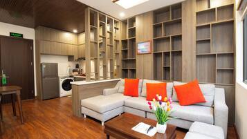 Deluxe Apartment, City View | Living area | 50-inch flat-screen TV with cable channels