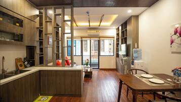 Deluxe Apartment, City View | Living area | 50-inch flat-screen TV with cable channels