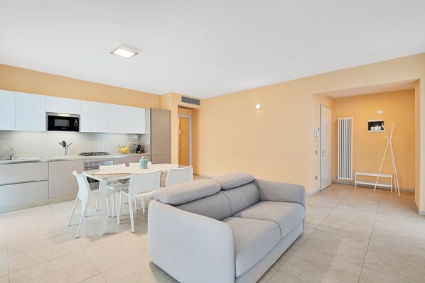 A modern apartment with a kitchen, dining area, and living room.