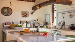 A kitchen with a marble island, green cabinets, and various kitchen items. - Podere La Troscia is an enchanting Rustic Villa in the Versilia countryside on the Tuscan coast with Garden and Private Pool; the owners love to share this wonderful place with guests from all over the world who intend to visit the North of Tuscany, the  (Piano di Mommio)
