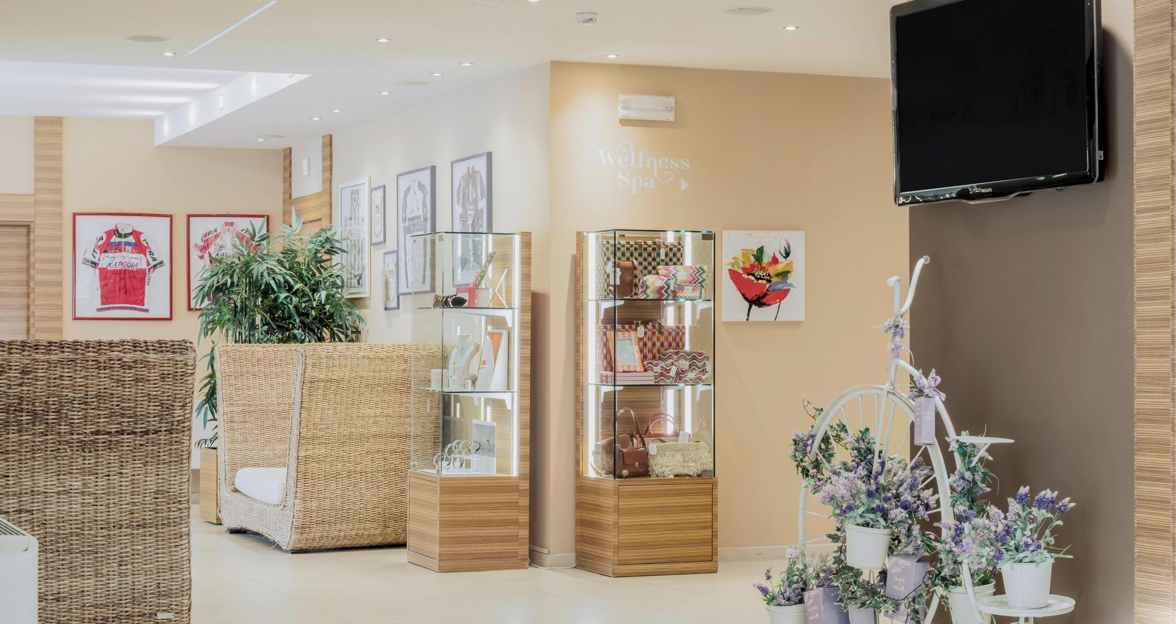 A modern interior with wicker furniture, glass display cases, and wall-mounted artwork.