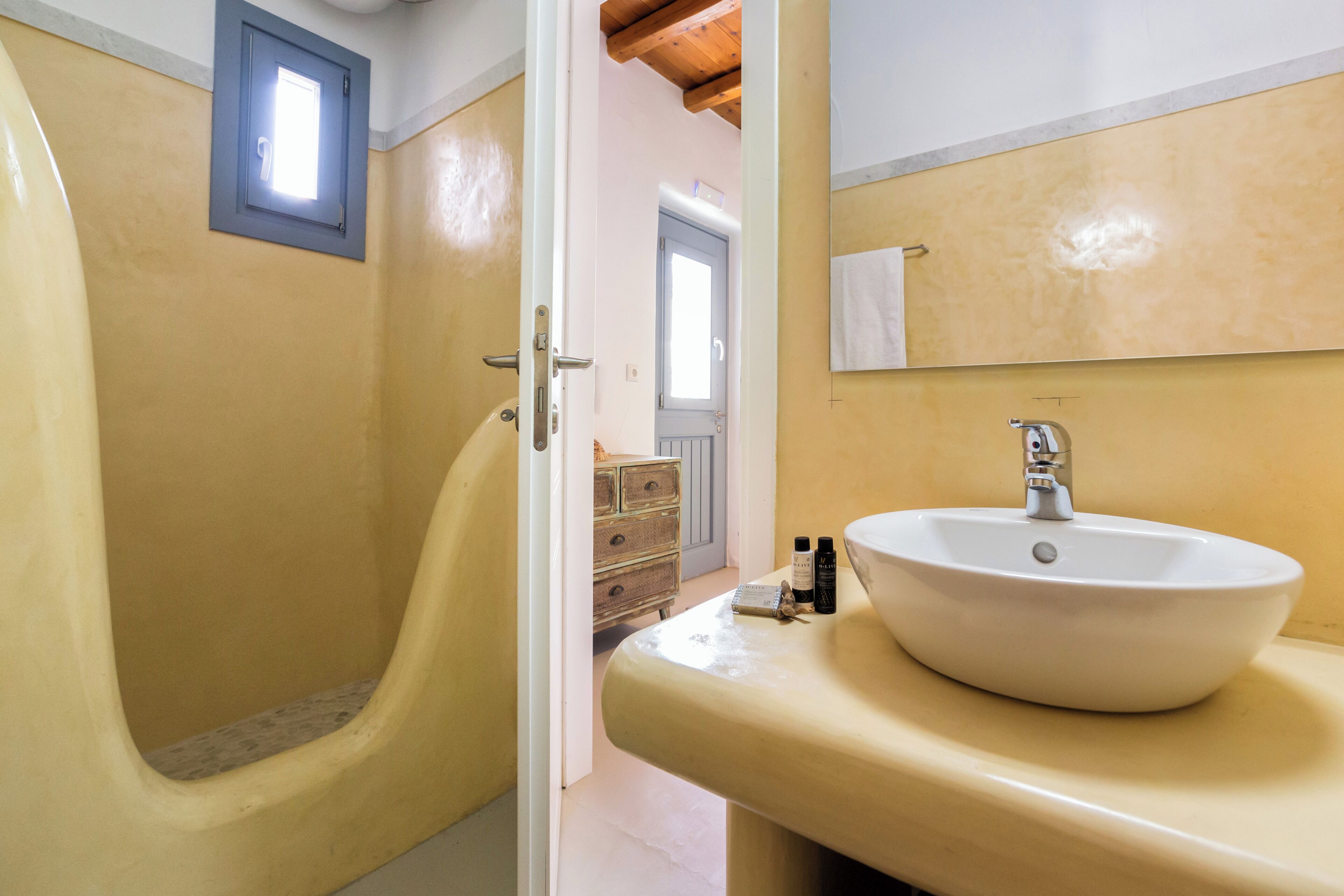 A bathroom with a bathtub, a sink, and a mirror.