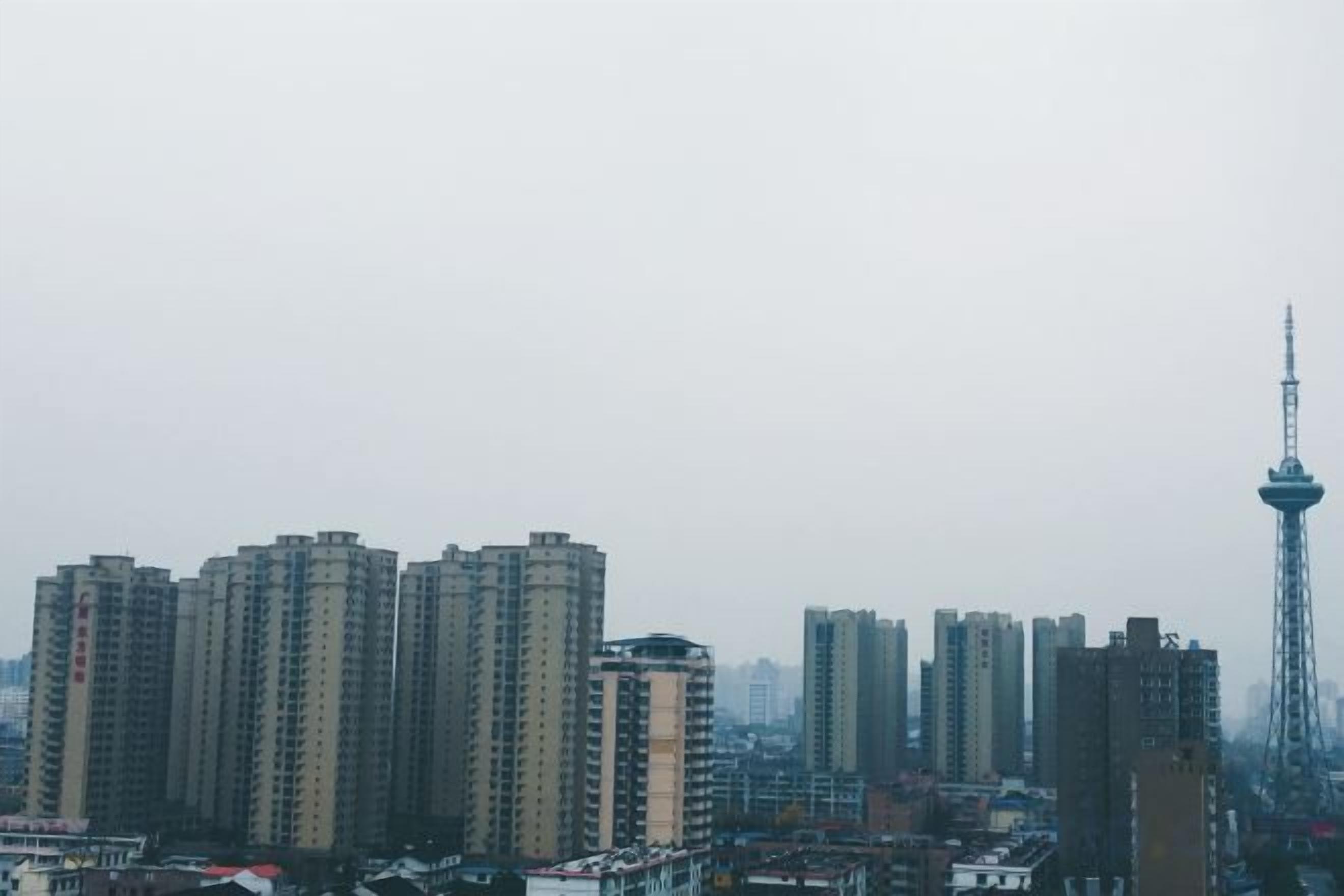 A cityscape with high-rise buildings and a tower structure.