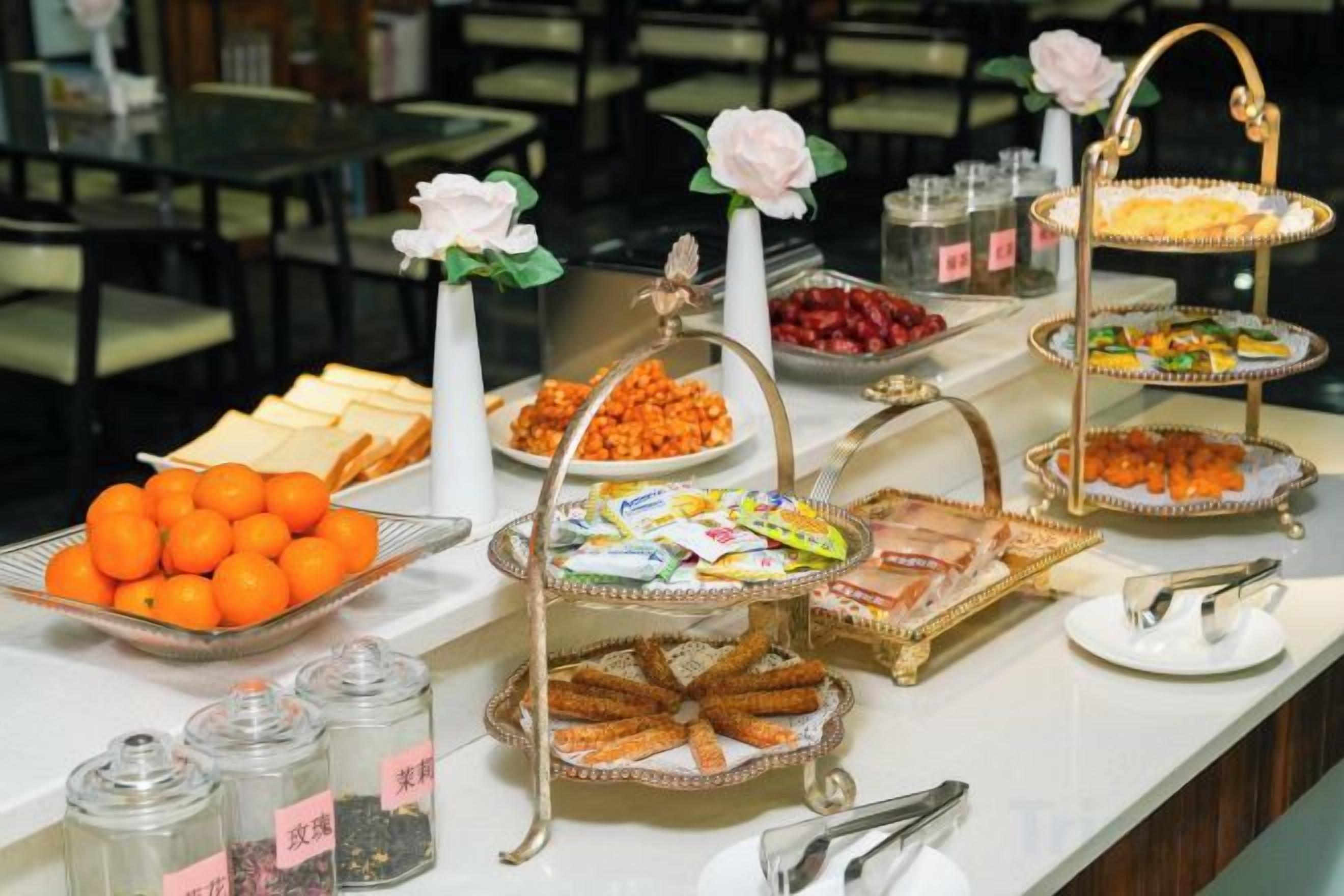 A buffet with various food items and decorative elements.