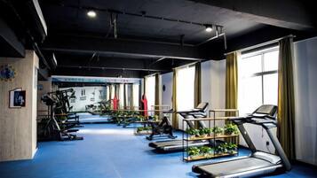 A gym with treadmills, stationary bikes, and weight machines.