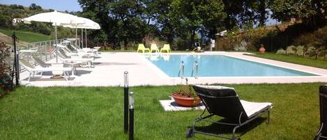 Seasonal outdoor pool, open 9:00 AM to 7:00 PM, pool umbrellas
