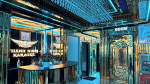 A karaoke bar with a mirrored ceiling and a large number '9999' sign. - Paloma Hotel (Van Don)