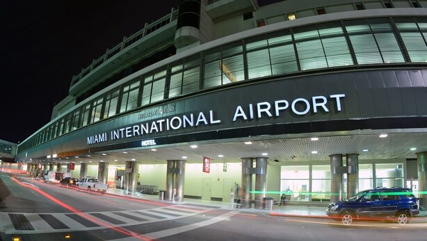 The exterior of Miami International Airport with a Wilcox Field Hotel sign.