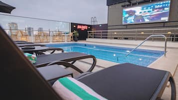 Outdoor pool, open 10:00 AM to 6:00 PM, pool umbrellas