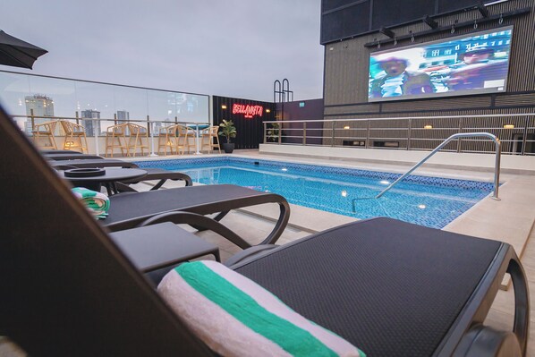 Outdoor pool, open 10:00 AM to 6:00 PM, pool umbrellas