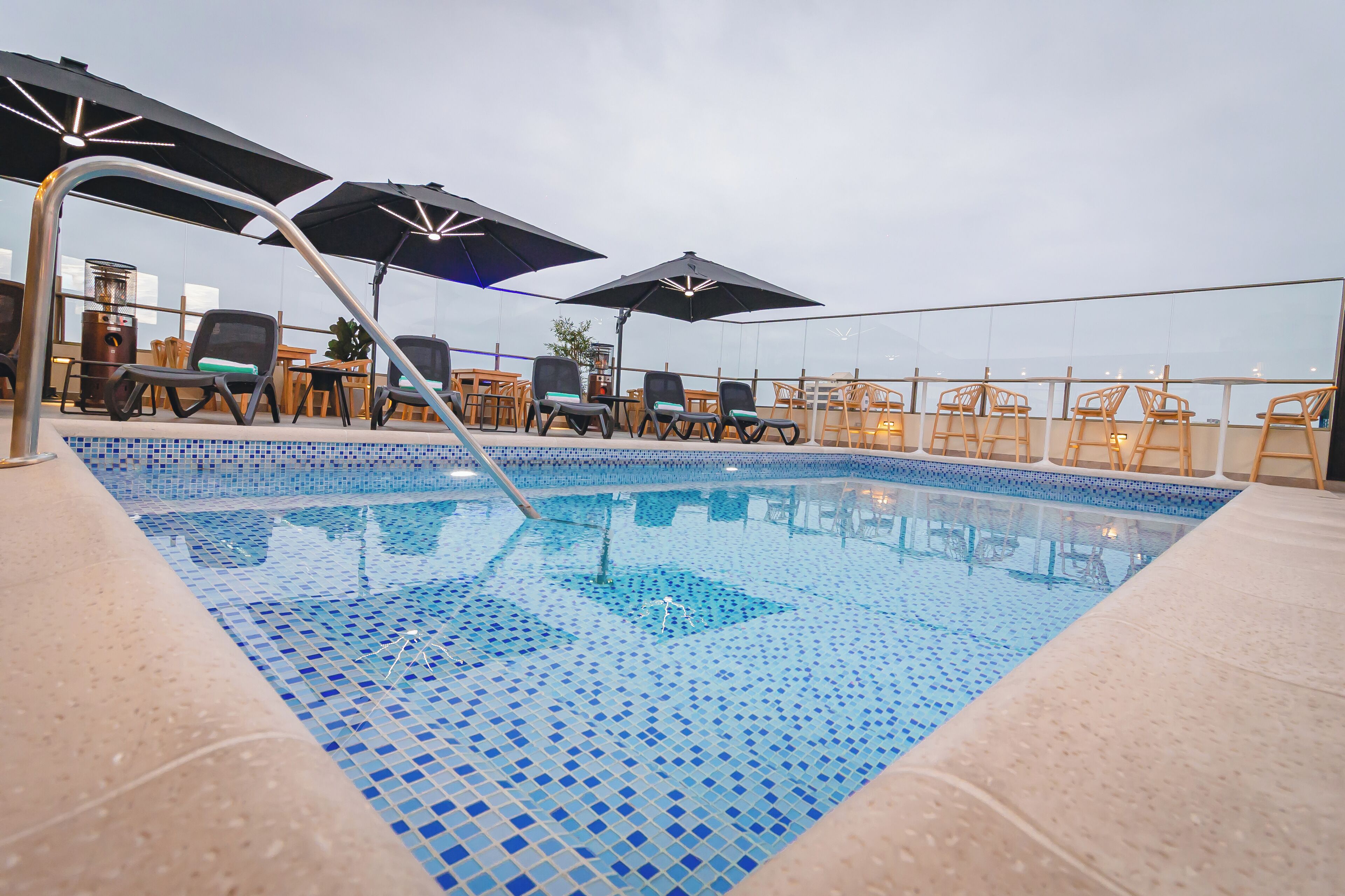 Outdoor pool, open 10:00 AM to 6:00 PM, pool umbrellas