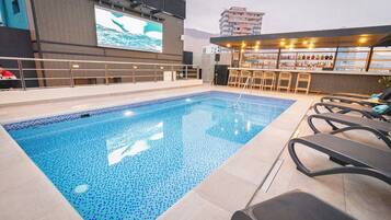 Outdoor pool, open 10:00 AM to 6:00 PM, pool umbrellas