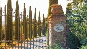 A gated entrance with a sign reading "Poggio Spinoso Villa Elena".