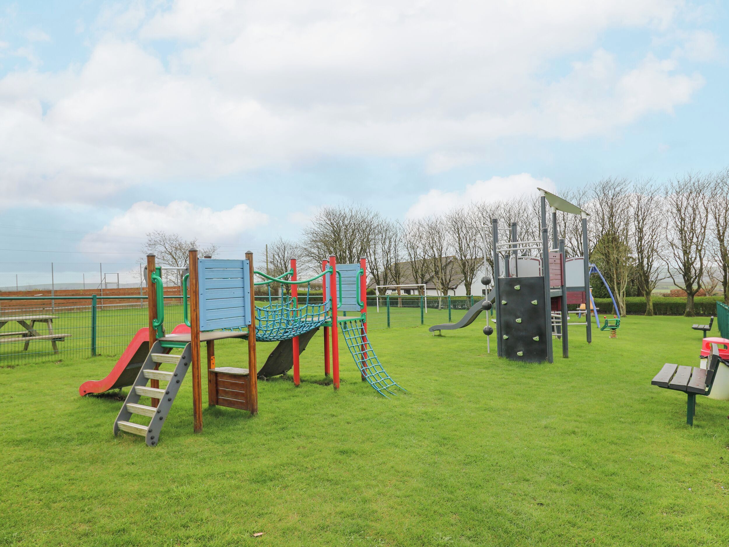 A playground with various play structures including slides and climbing areas.