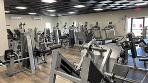 A gym with various exercise machines, including treadmills and weight machines, arranged in rows. - Spacious little condo at SML- Mariner's Landing Resort (Huddleston)