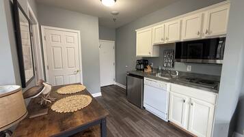 Fridge, microwave, coffee/tea maker, cookware/dishes/utensils