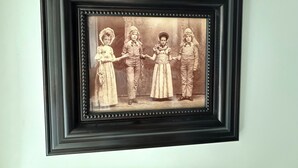 A framed vintage photograph of four children in period clothing. - Historical B&B located in New York's Finger Lakes Region (Seneca Falls)