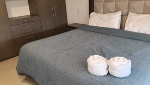 A hotel room with a bed, a wardrobe, and a headboard. - Coahuila, in the heart of Roma Norte (Ciudad de México)