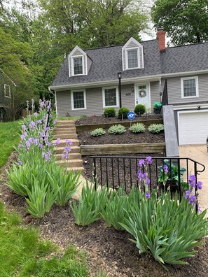 A residential house with a front yard, a mailbox, and a driveway.