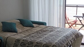 Enjoy a restful stay in this inviting room with a large bed and a balcony offering a view of the sea.