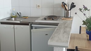 Enjoy cooking in this well-equipped kitchen with a stainless steel sink, dishwasher, and compact refrigerator.