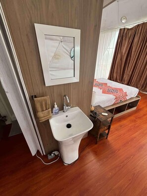 A bathroom with a sink, a towel rack, and a mirror. - Lovers and Kids Nest (Denison)