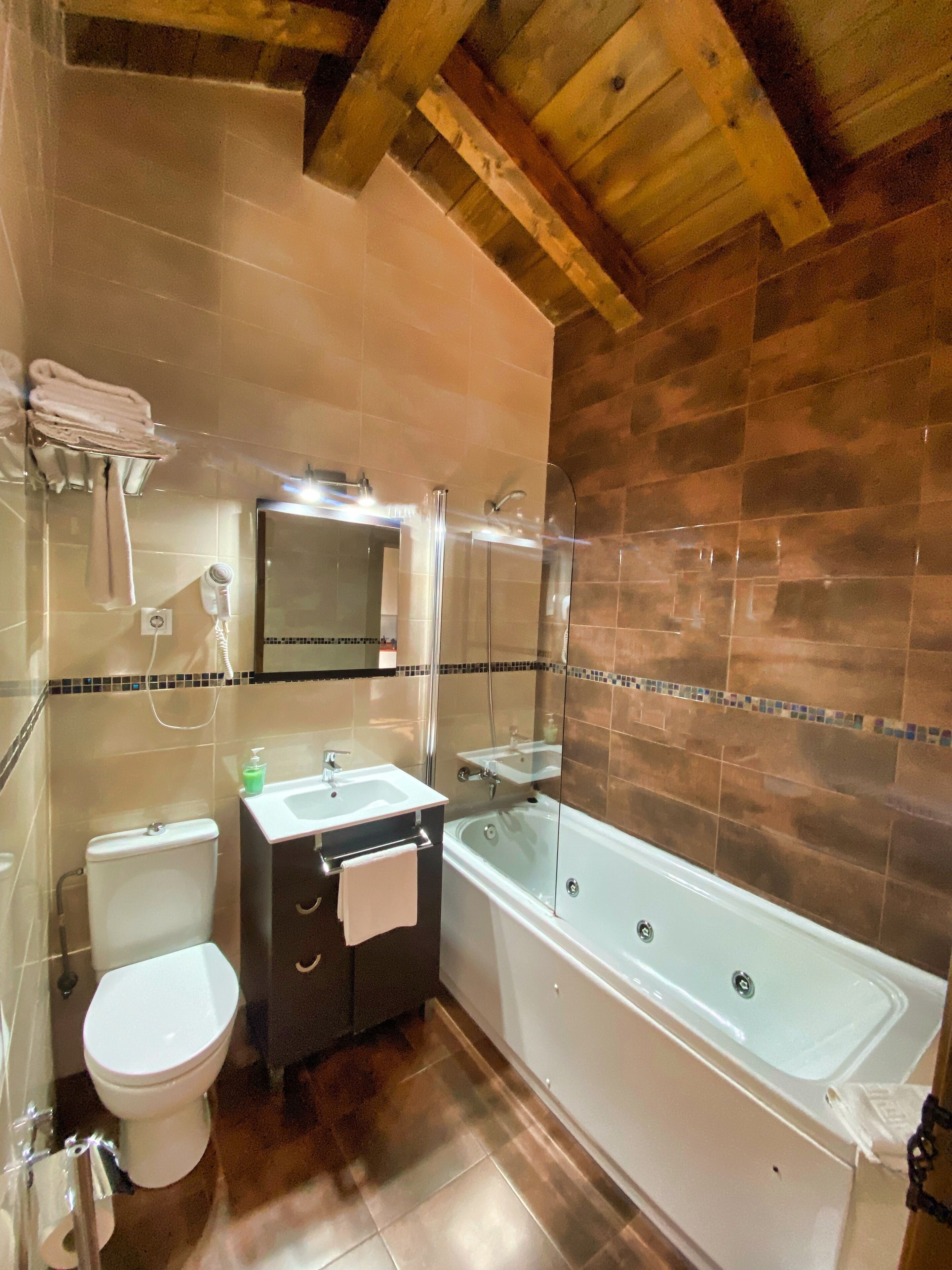 A bathroom with a toilet, sink, and bathtub.