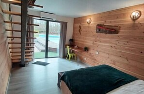 Family Room, Pool View | Desk, laptop workspace, soundproofing, free WiFi