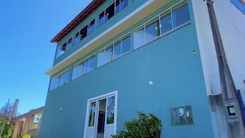 A two-story building with a flat roof and large windows.